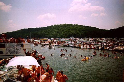 1982 Ford Bronco - A crowded lake scene with numerous boats and people enjoying a sunny day on the water.