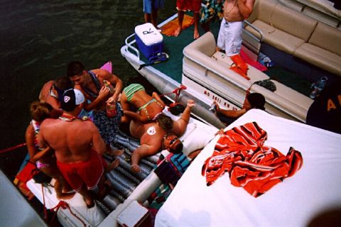 1982 Ford Bronco - A group of people are enjoying a day on the water, crowded onto two boats.