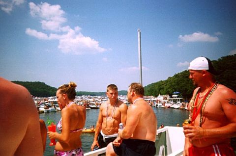 1982 Ford Bronco - A group of people enjoy a sunny day on a boat, surrounded by numerous other vessels on the water.