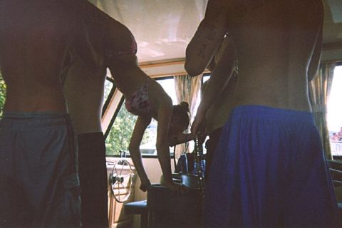 1982 Ford Bronco - A group of people are enjoying time on a boat, with one person performing a gymnastic move.