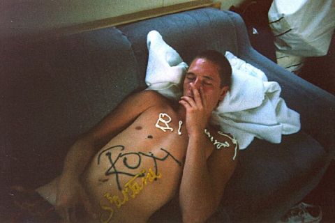 1982 Ford Bronco - Man with frosting writing on his chest lies on a couch.