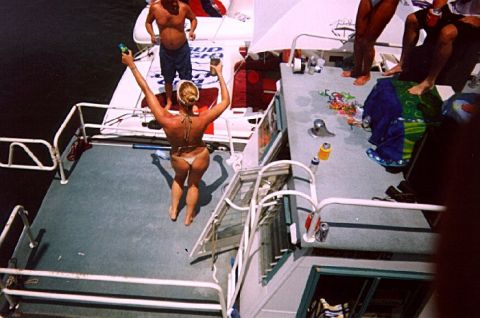 1982 Ford Bronco - People enjoying a day on the water, with one person preparing to jump off the boat.