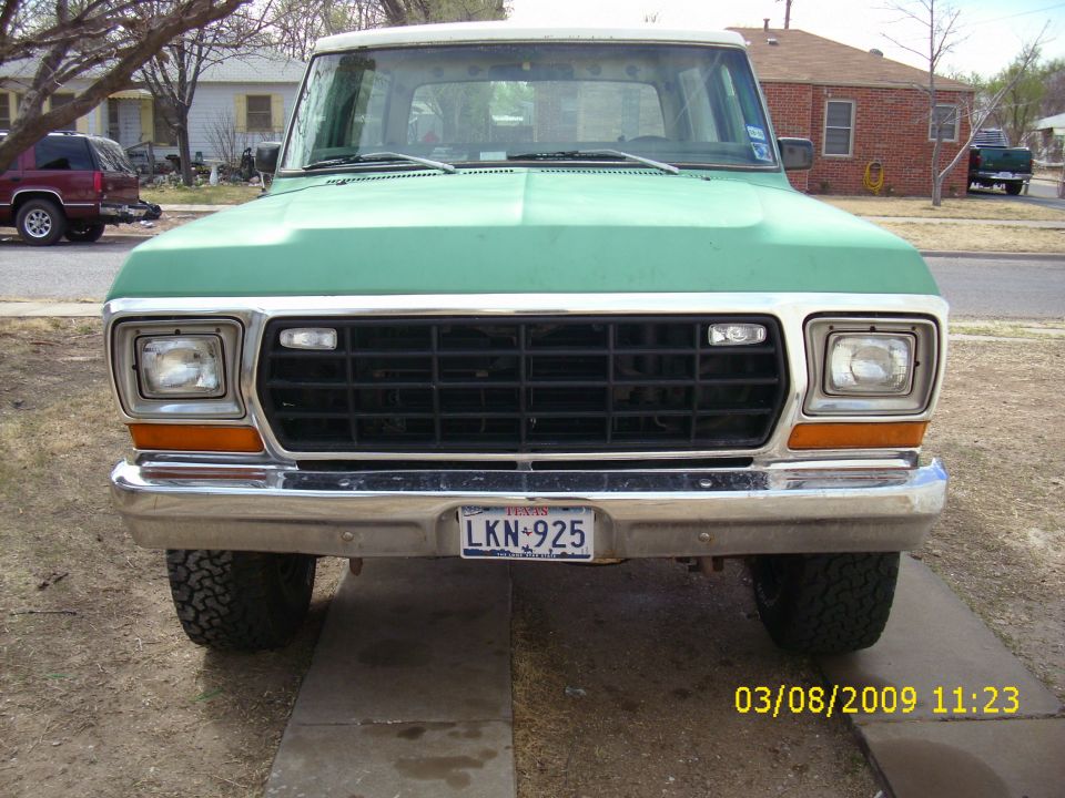 Front of green and white 1978 Ford Bronco with chrome bumper and Texas plate LKN-925
