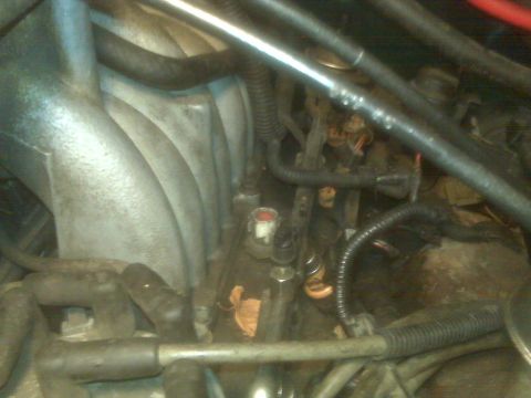 1995 Ford Bronco - This is a close-up view of the engine bay of a 1995 Ford Bronco, focusing on the fuel injectors and intake manifold.