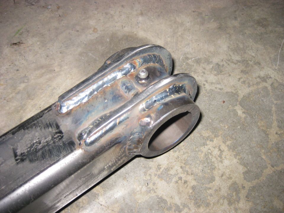 Welded metal part with a circular opening on a concrete floor.