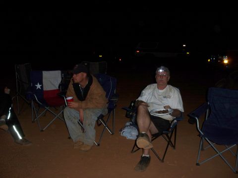 1996 Ford Bronco - Men sit in camping chairs outdoors at night, with a Texas flag visible on one chair.