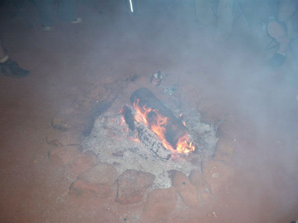 Campfire with logs burning and smoke rising