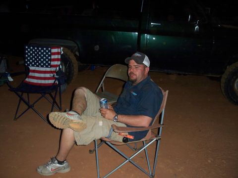 1996 Ford Bronco - A dark green pickup truck is visible in the background at night.