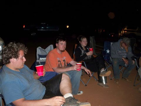1996 Ford Bronco - People gathered around a campfire at night, with a truck in the background.