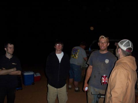 1996 Ford Bronco - A group of men gather outdoors at night, with a dark background and some coolers visible.