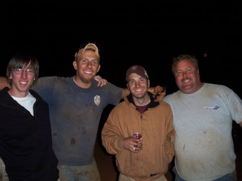 1996 Ford Bronco - Four men covered in dirt smile for a photo taken at night.