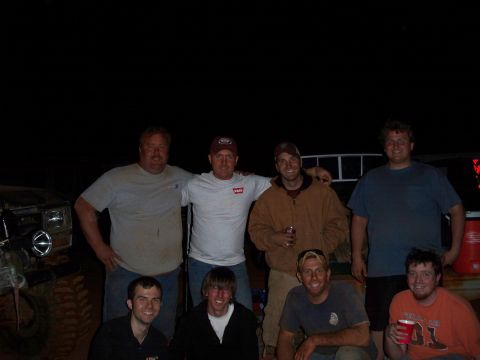 1996 Ford Bronco - A group of men gathered together for a photo at night, with a vehicle in the background.