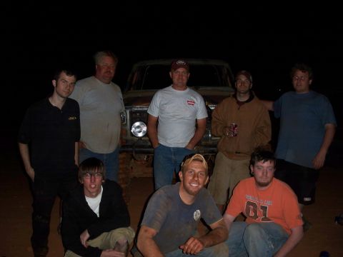 1996 Ford Bronco - A group of men pose for a photo in front of a vintage Ford pickup truck after an event.