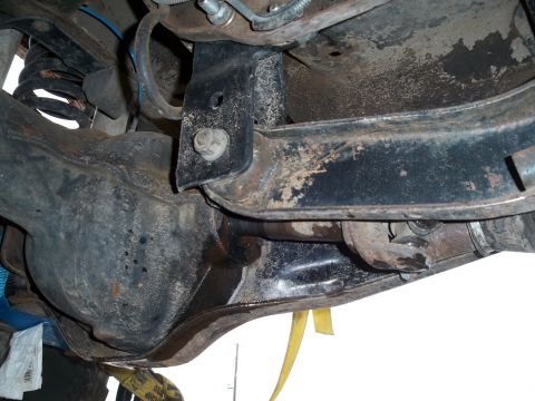 1996 Ford Bronco - Close-up view of the rear axle and suspension system, showing various mechanical parts.