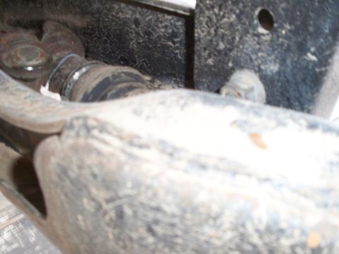 1996 Ford Bronco - Detail of a vehicle's driveshaft boot and U-joint, likely needing maintenance.