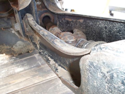 1996 Ford Bronco - This image shows a close-up of a heavily rusted vehicle suspension component, likely part of the drivetrain or steering system.