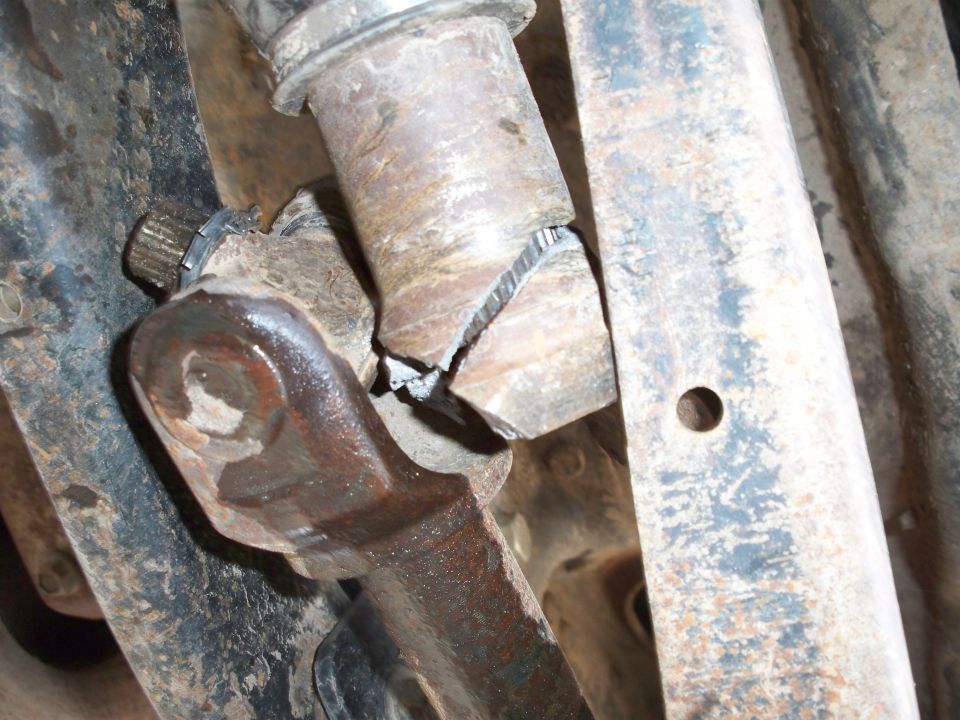 Close-up of a broken steering linkage with metal fatigue and fracture