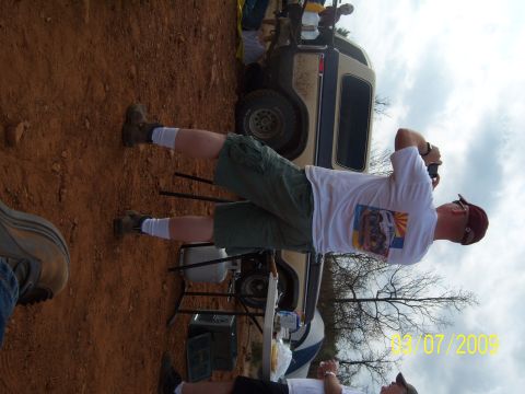 1996 Ford Bronco - A tan and blue SUV is visible in the background, with people gathered around.