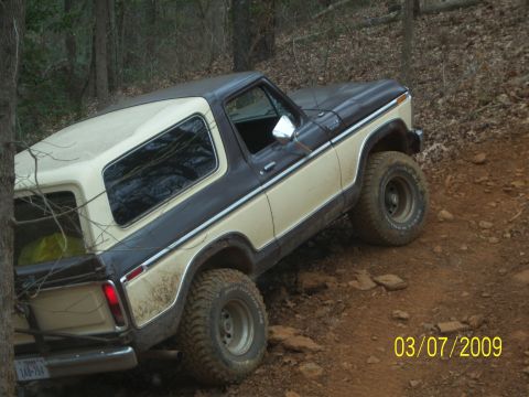 1996 Ford Bronco - This 1978 Ford Bronco is shown off-road on a muddy, wooded trail.