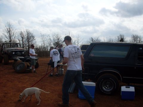 1996 Ford Bronco - Outdoor gathering with multiple off-road vehicles and people on a dirt lot.