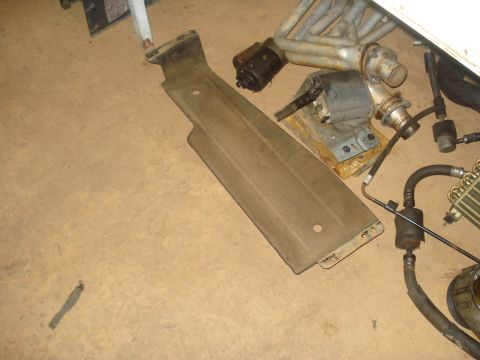 1991 Ford Bronco - Various disassembled vehicle components are spread across the floor, suggesting a repair or restoration project.