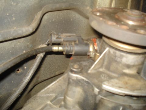 1991 Ford Bronco - A close-up view of a sensor and wiring connected to a vehicle's transmission or transfer case.