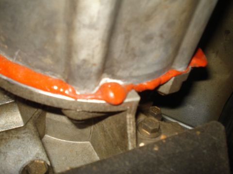 1991 Ford Bronco - Close-up of an engine component showing sealant application.