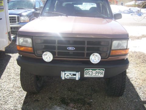 1993 Ford Bronco - Front view of a brown Ford Bronco with a winch mounted on the bumper.