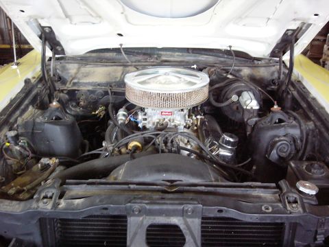 1971 Ford Ranchero - The engine bay of a 1971 Ford Ranchero shows a V8 engine with an aftermarket air cleaner and yellow paint on the fender.