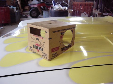 1971 Ford Ranchero - A cardboard box is placed on the hood of a car with flame graphics.