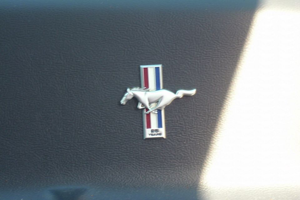 Chrome Ford Mustang running-horse emblem with 35 Years badge