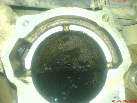 1992 Ford Crown Victoria - This image shows a dirty engine part, likely related to emissions control, with significant carbon buildup.