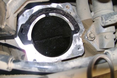 1992 Ford Crown Victoria - EGR valve showing significant carbon deposits and a damaged gasket.
