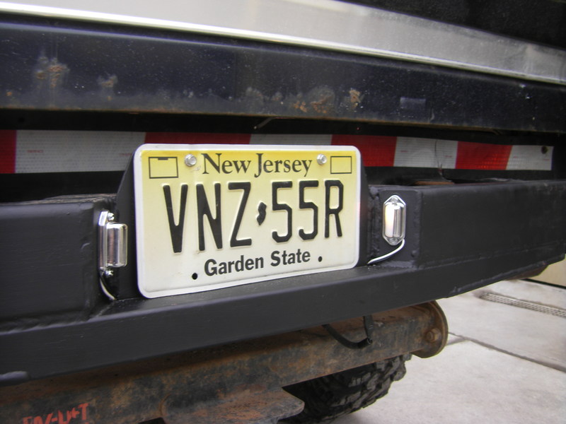 New Jersey license plate on a black custom rear bumper with chrome plate lights