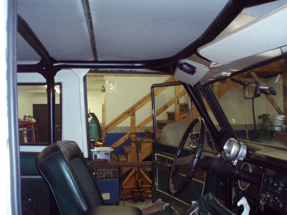 Inside a Ford Bronco, looking toward the dashboard and passenger side. Roll cage installed