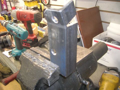 1996 Ford Bronco - Metal bracket secured in a vise, with power tools visible in the workshop setting.