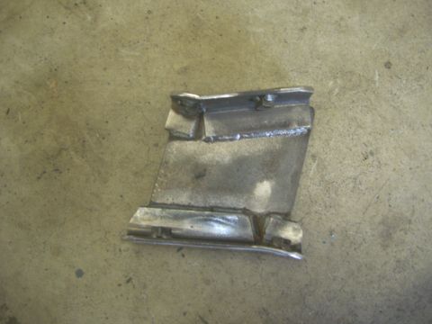 1996 Ford Bronco - A welded metal bracket is shown on a concrete surface.