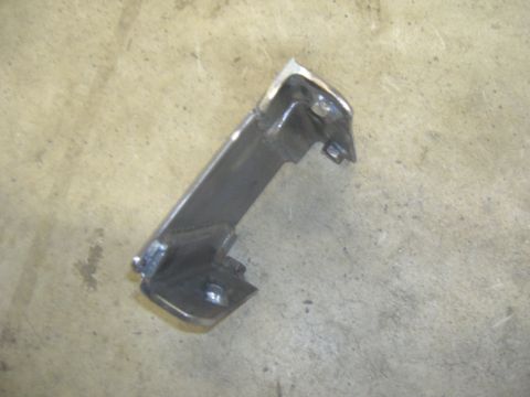 1996 Ford Bronco - A single metal bracket is shown against a concrete background, likely a component from a larger assembly.