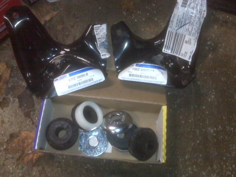 1995 Ford Bronco - New Ford Bronco suspension parts, including brackets and bushings, are laid out in a box.