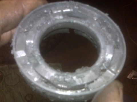 1995 Ford Bronco - A close-up shows a worn metal ring with visible debris and damage around its inner edge.