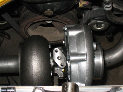 2001 Pontiac Trans Am - Close-up view of a turbocharger installation on an engine, showing various mechanical components.