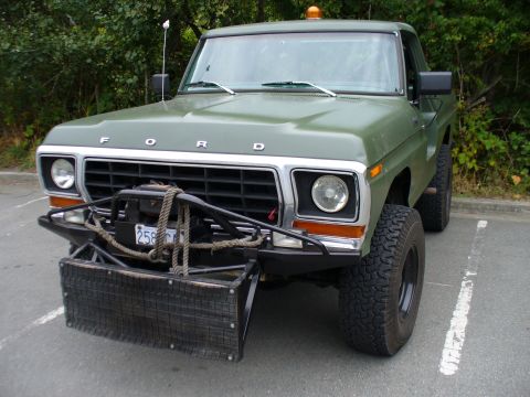 1978 Ford Bronco - This 1979 Ford F-Series truck is equipped with a front plow and winch, seen from the front.