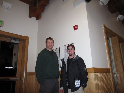 1992 Ford Bronco - Two men pose for a photo indoors, with wood paneling and a fire alarm visible on the wall.