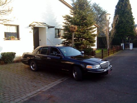 1998 Ford Crown Victoria - Black 1998 Ford Crown Victoria parked in front of a residential building.