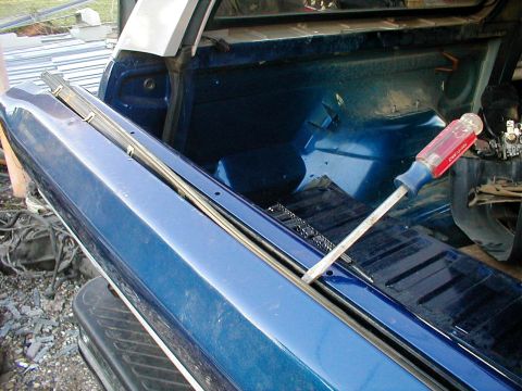 1983 Ford Bronco - AFTER removing the screw at each end, use a screwdriver to gently pry the OUTER weatherbelt up just enough to pop the cllps loose. I've pul…