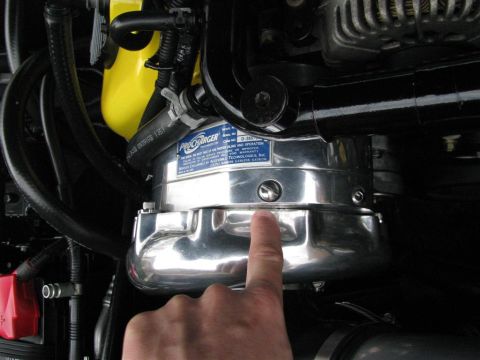 2003 Mercury Marauder - Close-up of a chrome ProCharger supercharger unit, with a finger pointing to it.