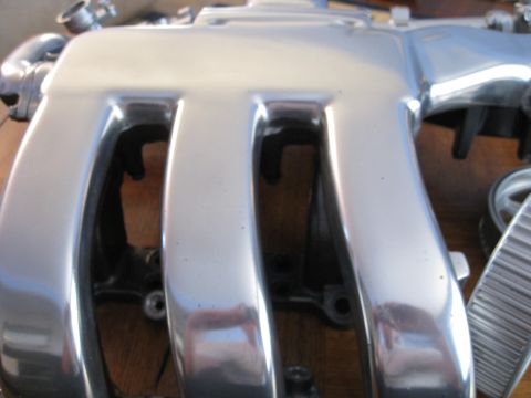 1994 Ford Probe - Close-up view of a polished chrome intake manifold, likely a performance upgrade part.