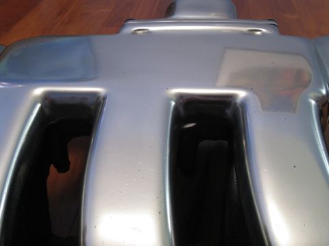 1994 Ford Probe - This is a close-up view of a chrome intake manifold, likely for an engine.