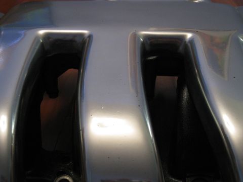 1994 Ford Probe - Close-up of a silver engine intake manifold, showing two dark openings and a website watermark.