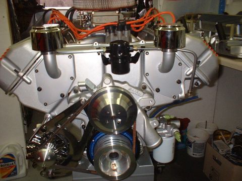 1970 Ford Mustang - Close-up view of a custom engine assembly, chrome accents and bright orange ignition wires.